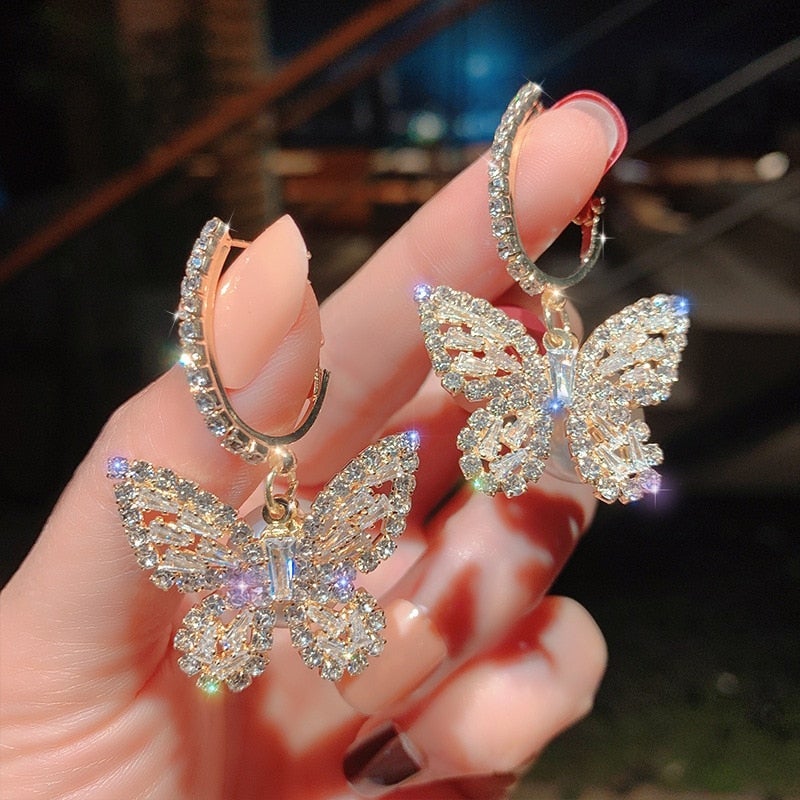 Zirflorine – Boucles d’oreilles dorées papillon avec zirconia
